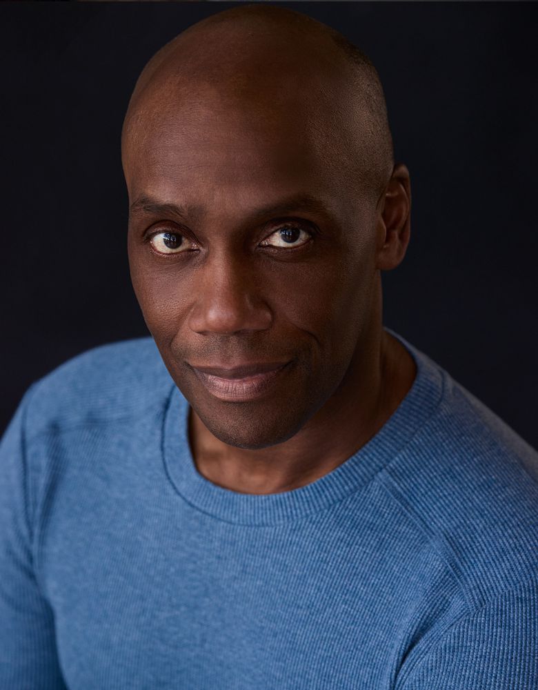 Head shot photo of actor Dalias Blake, wearing a blue shirt